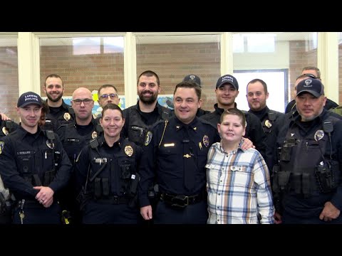 10-year-old battling brain cancer swears in as Lansing police officer [Video]